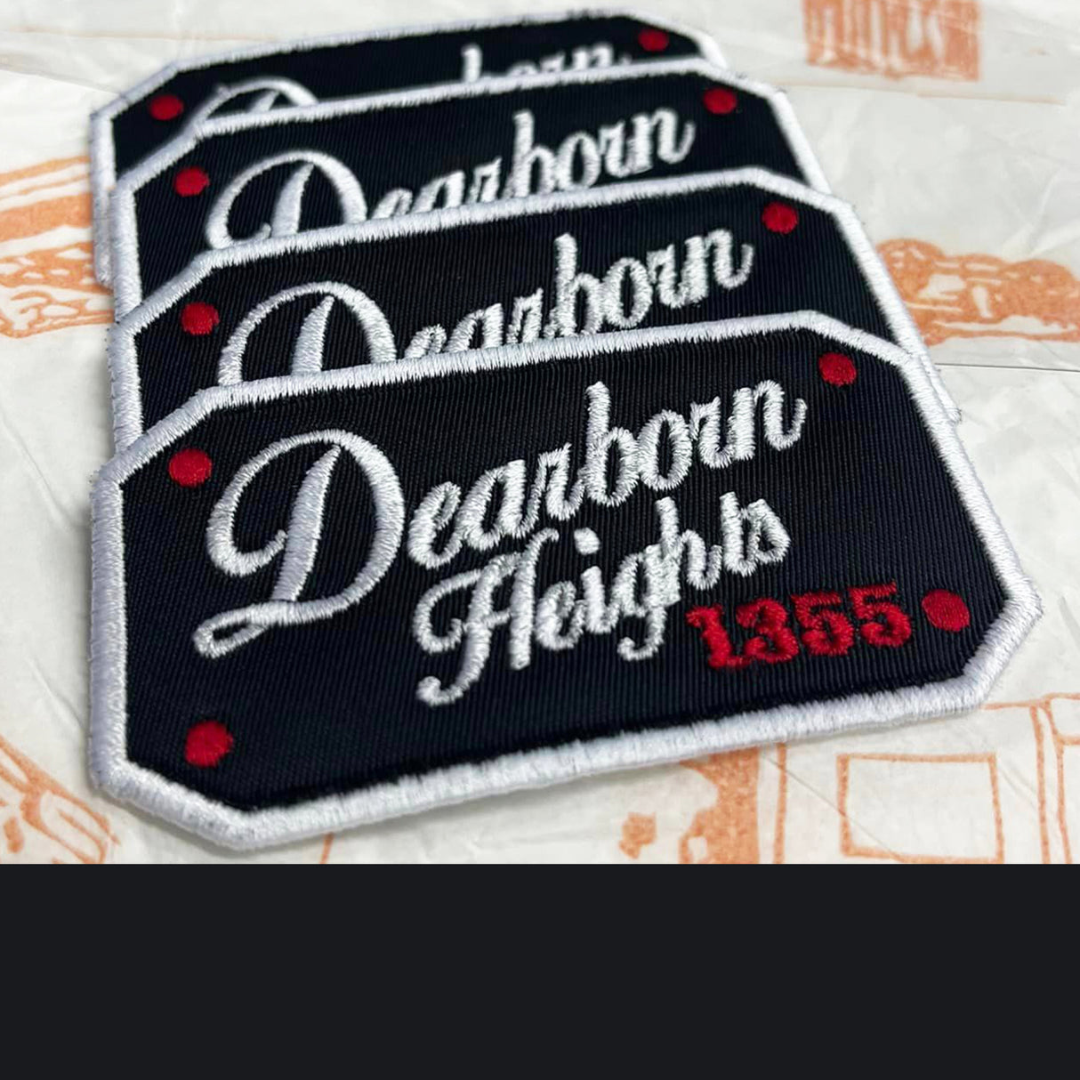 Stack of 'Dearborn Heights 1355' patches on a textured surface