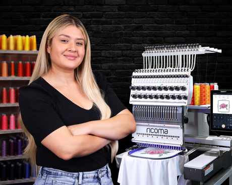 Woman standing in front of an embroidery machine swift 20 needles with colorful thread wall in the background